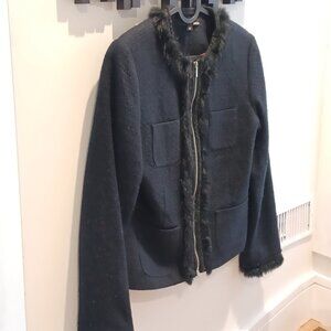 Black jacket with fake fur details by zipper, collar and cuffs.